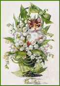 Chaton dans un bouquet de muguet fleuri